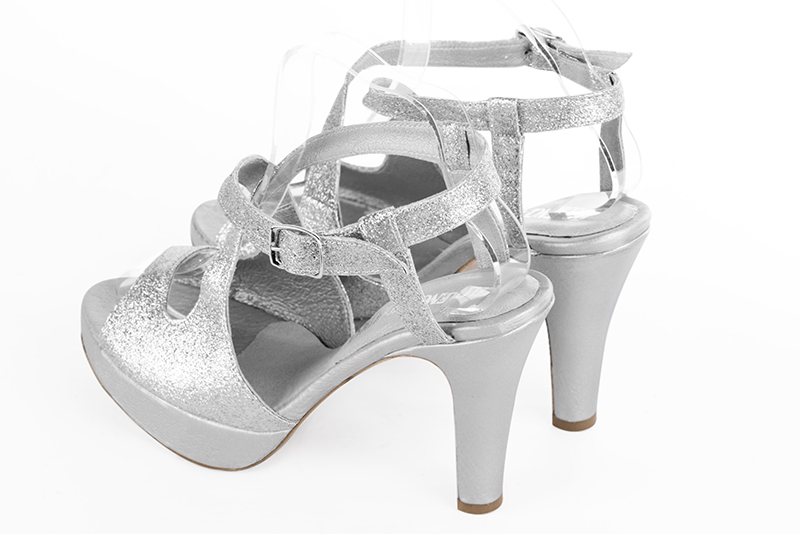 Light silver women's open back sandals, with crossed straps. Round toe. Very high slim heel with a platform at the front - Florence KOOIJMAN